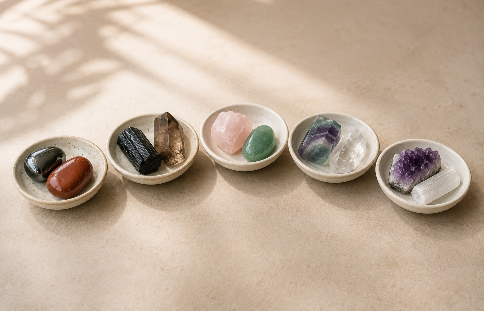 Five small bowls of crystals grouped by energetic role